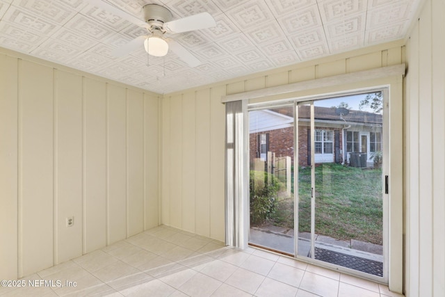 unfurnished room with light tile patterned floors, an ornate ceiling, and a ceiling fan