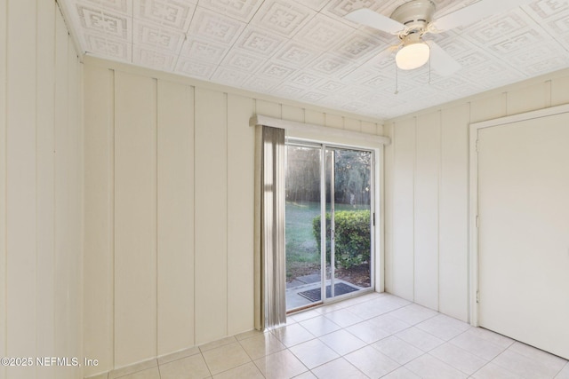 spare room featuring an ornate ceiling, light tile patterned flooring, and a ceiling fan