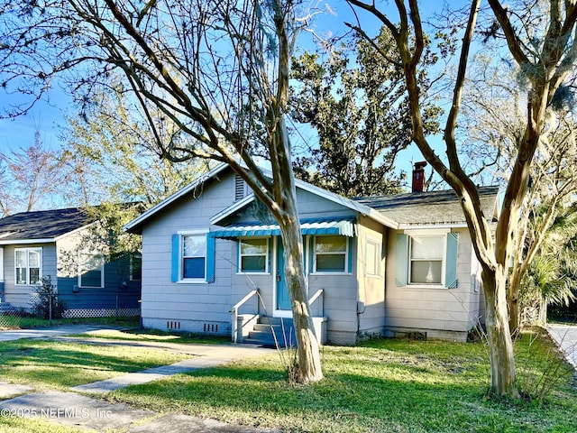 bungalow featuring crawl space, a chimney, and a front yard