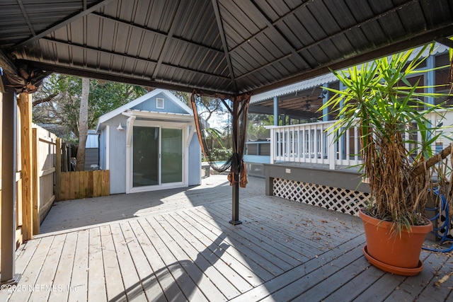 deck with fence, an outbuilding, and a gazebo