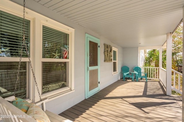 wooden terrace featuring covered porch