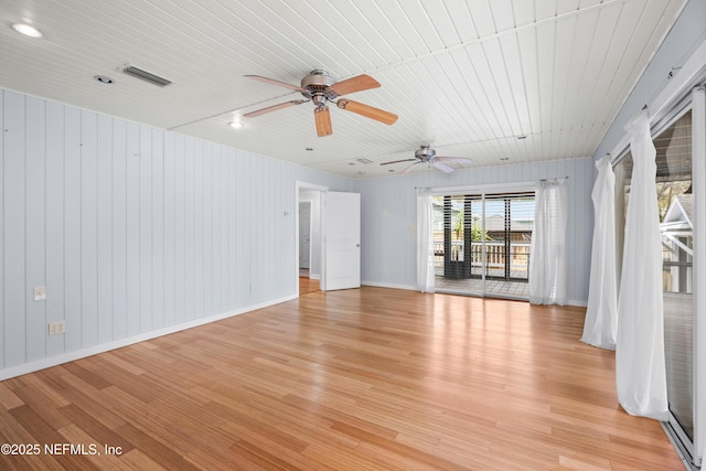 unfurnished room featuring baseboards, wooden ceiling, visible vents, and light wood-style floors