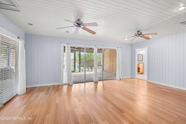 spare room featuring light wood-style floors, baseboards, and visible vents