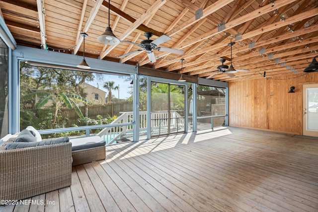 wooden terrace with ceiling fan and fence