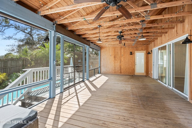 unfurnished sunroom with wooden ceiling and ceiling fan