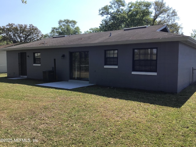 back of house featuring concrete block siding, a shingled roof, a lawn, a patio area, and cooling unit