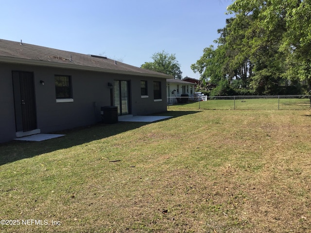 view of yard featuring a fenced backyard and central air condition unit