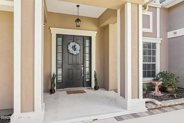 property entrance featuring stucco siding