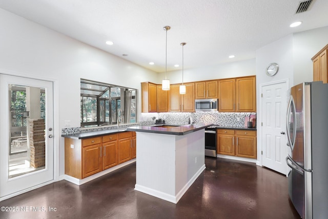 kitchen featuring visible vents, appliances with stainless steel finishes, brown cabinets, tasteful backsplash, and dark countertops