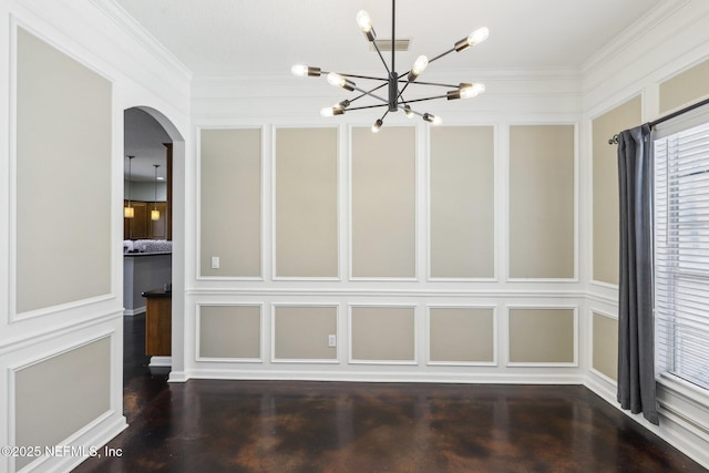 unfurnished dining area featuring crown molding, arched walkways, a decorative wall, and wood finished floors