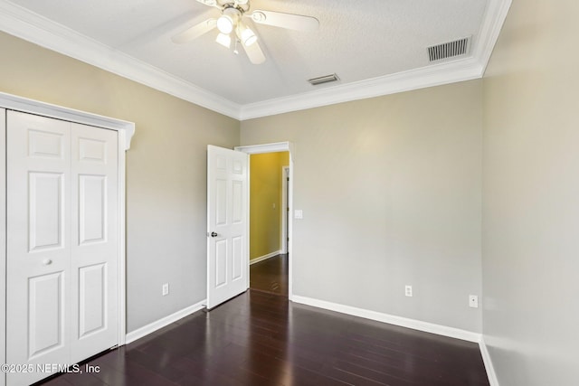 unfurnished bedroom with baseboards, visible vents, and wood finished floors