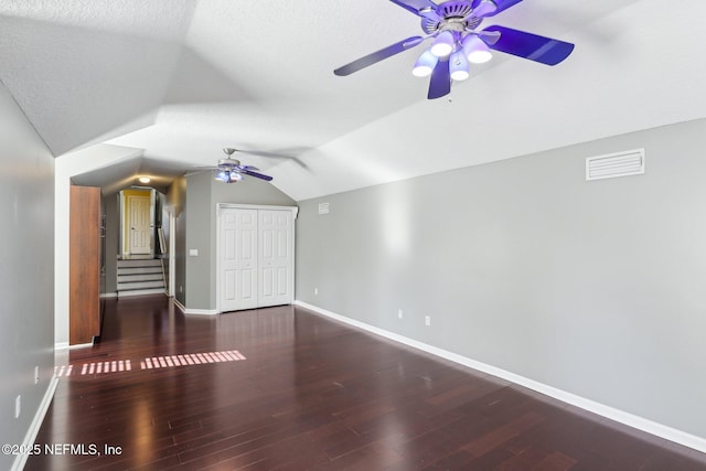 bonus room with lofted ceiling, visible vents, a ceiling fan, wood finished floors, and baseboards