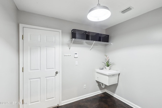 washroom with baseboards and visible vents