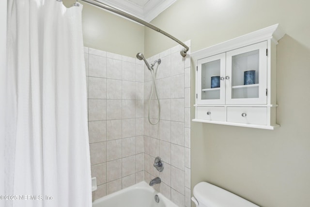 bathroom featuring toilet, ornamental molding, and shower / tub combo with curtain