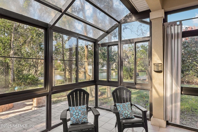 unfurnished sunroom featuring a water view