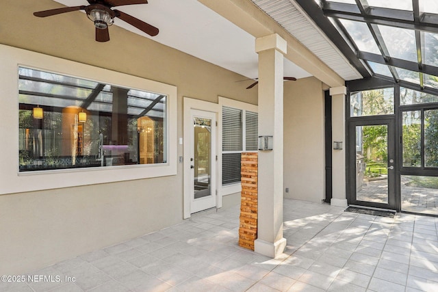 view of patio / terrace featuring ceiling fan and a lanai