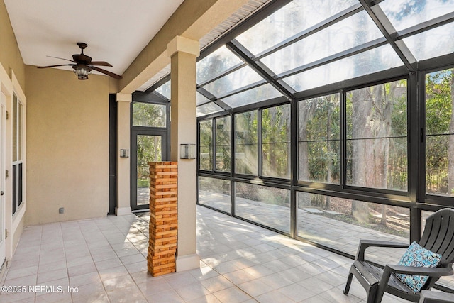 unfurnished sunroom with a ceiling fan