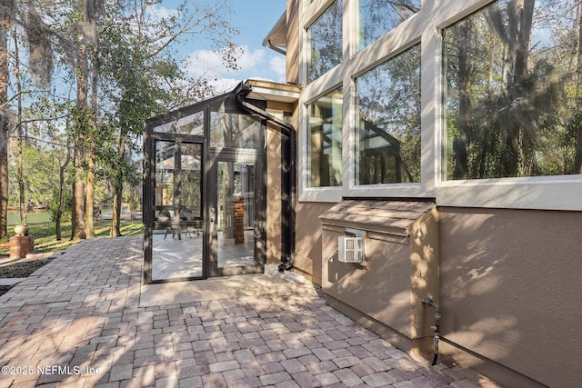 view of patio with a sunroom