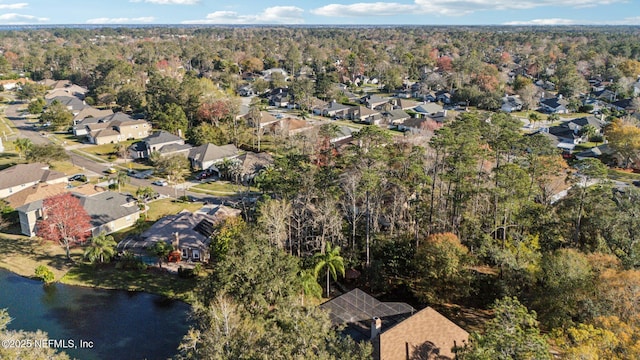 bird's eye view with a residential view, a water view, and a wooded view