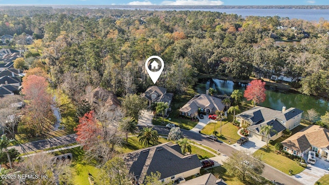 aerial view featuring a water view, a forest view, and a residential view