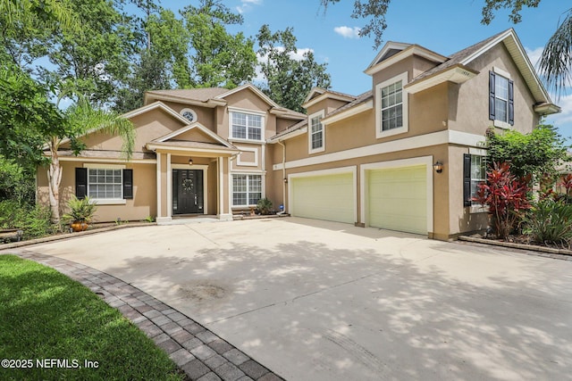 1494 Walnut Creek Dr, Fleming Island, FL 32003 - view of front of property featuring a garage, stucco siding, and driveway