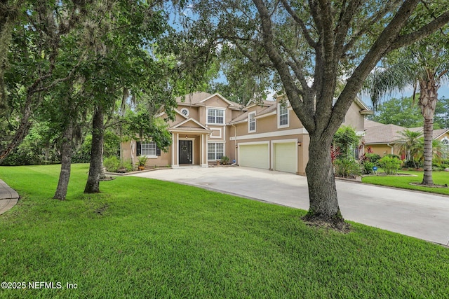 1494 Walnut Creek Dr, Fleming Island, FL 32003 - view of front facade featuring stucco siding, an attached garage, concrete driveway, and a front yard