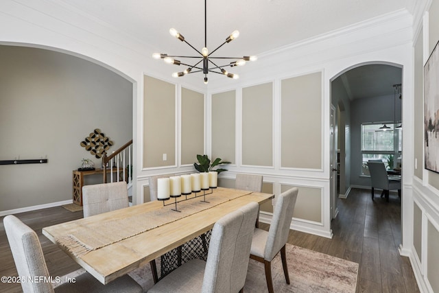 1494 Walnut Creek Dr, Fleming Island, FL 32003 - dining space with arched walkways, a decorative wall, a chandelier, ornamental molding, and dark wood-type flooring