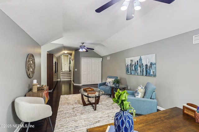 1494 Walnut Creek Dr, Fleming Island, FL 32003 - living area featuring ceiling fan, vaulted ceiling, dark wood finished floors, and stairs
