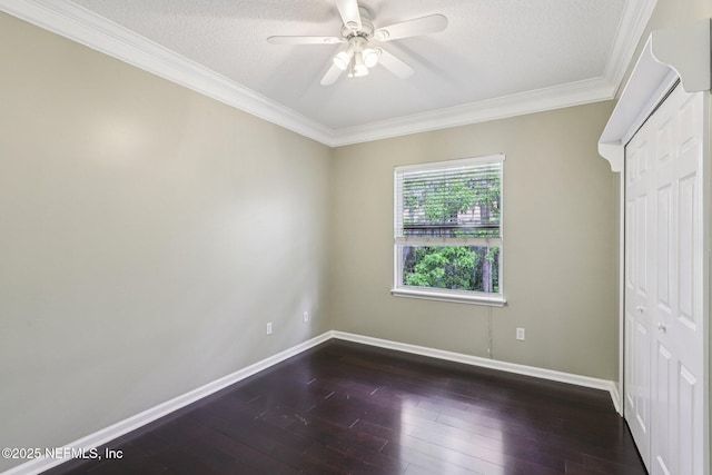 1494 Walnut Creek Dr, Fleming Island, FL 32003 - unfurnished bedroom with ornamental molding, dark wood-style floors, a textured ceiling, ceiling fan, and a closet