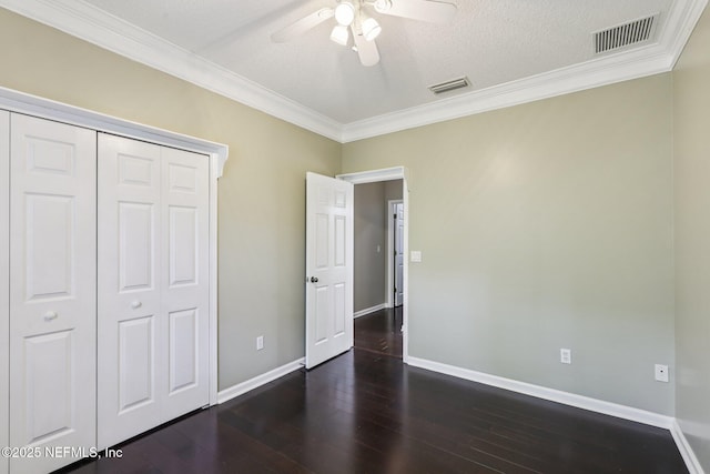 1494 Walnut Creek Dr, Fleming Island, FL 32003 - unfurnished bedroom featuring ornamental molding, dark wood-style flooring, a closet, and ceiling fan
