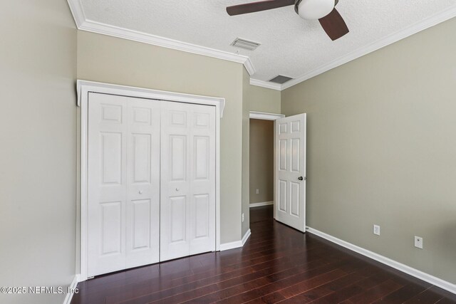 1494 Walnut Creek Dr, Fleming Island, FL 32003 - unfurnished bedroom featuring wood finished floors, a closet, crown molding, a textured ceiling, and a ceiling fan