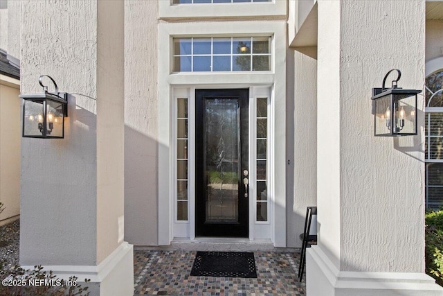 property entrance featuring stucco siding