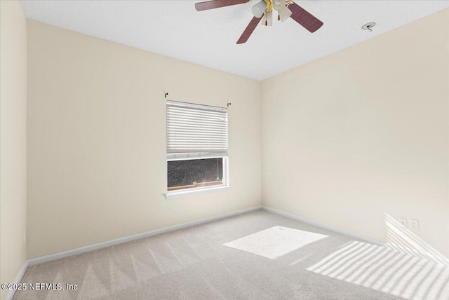 unfurnished room featuring carpet, baseboards, and a ceiling fan