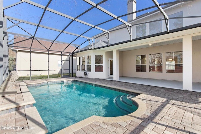 pool with a lanai and a patio area