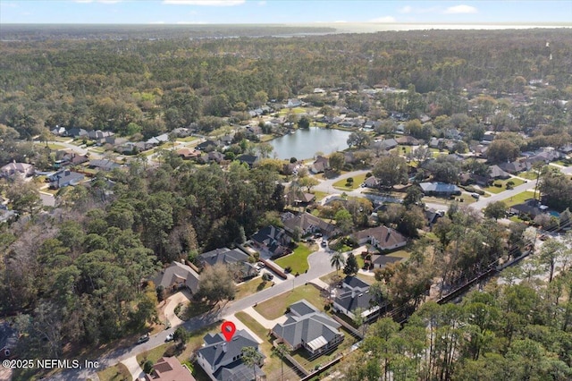 birds eye view of property with a residential view, a water view, and a wooded view