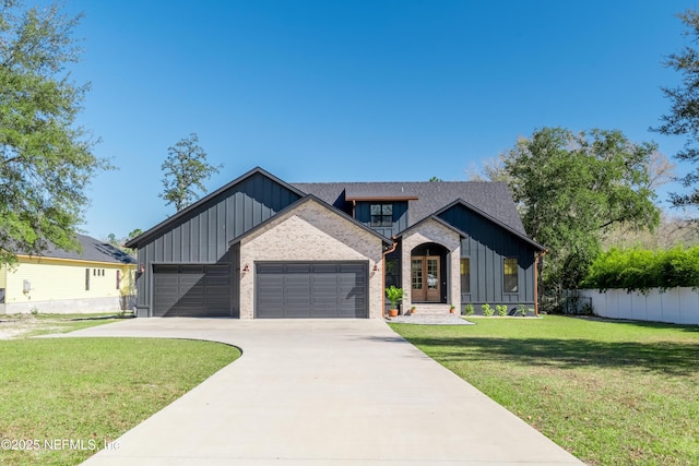 modern inspired farmhouse featuring board and batten siding, fence, a garage, driveway, and a front lawn