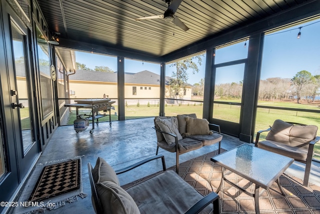 sunroom with a wealth of natural light and ceiling fan