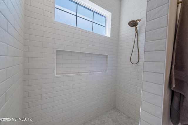 full bath featuring a tile shower