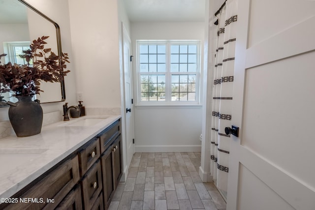 doorway featuring a sink and baseboards