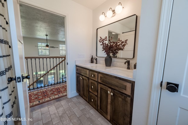 full bathroom featuring double vanity, a sink, and a ceiling fan