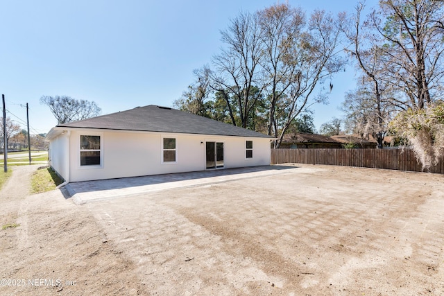 back of property featuring a patio area, fence, and stucco siding