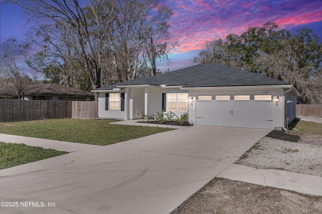 single story home with a garage, driveway, fence, and a lawn