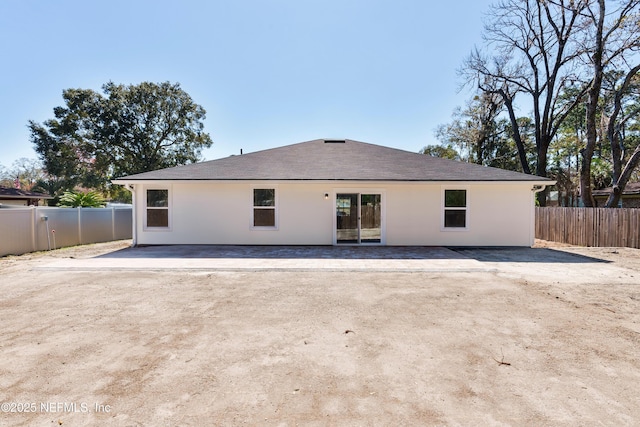 back of house with a patio area, fence, and stucco siding