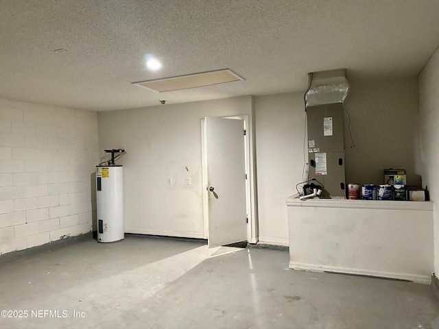 garage with concrete block wall, heating unit, and water heater