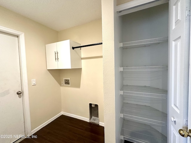 laundry room featuring hookup for a washing machine, a textured ceiling, baseboards, and dark wood-type flooring