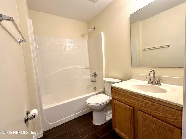 bathroom with vanity, bathing tub / shower combination, wood finished floors, and toilet