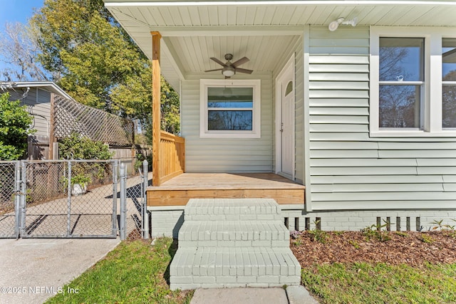 doorway to property with ceiling fan, crawl space, fence, and a gate