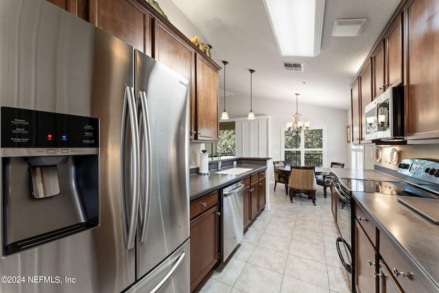 kitchen featuring lofted ceiling, stainless steel appliances, a sink, visible vents, and dark countertops