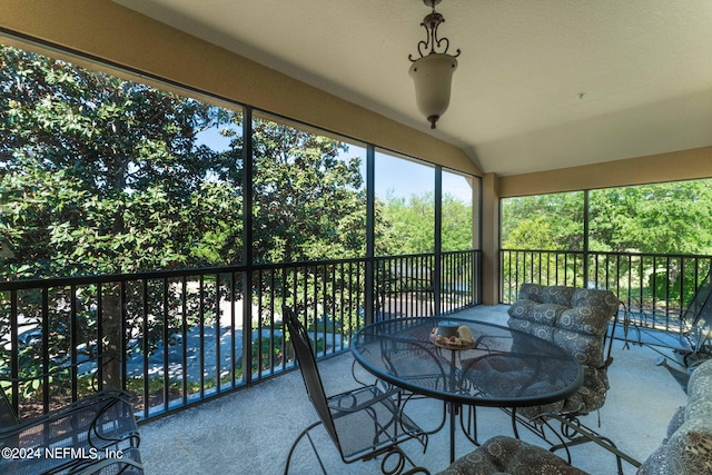 sunroom / solarium featuring vaulted ceiling