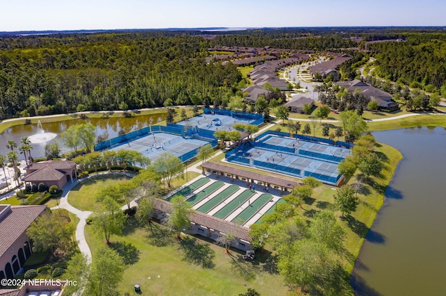 aerial view with a water view and a forest view